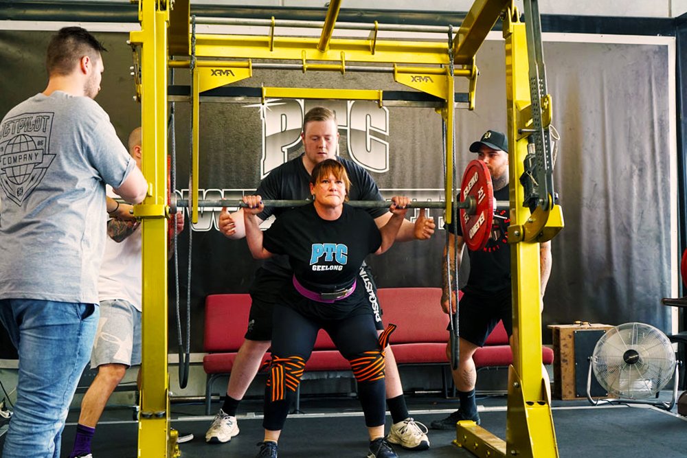 Woman lifting during powerlifting event at PTC