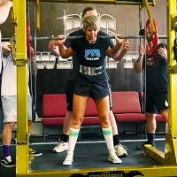 Woman lifting during powerlifting event at PTC